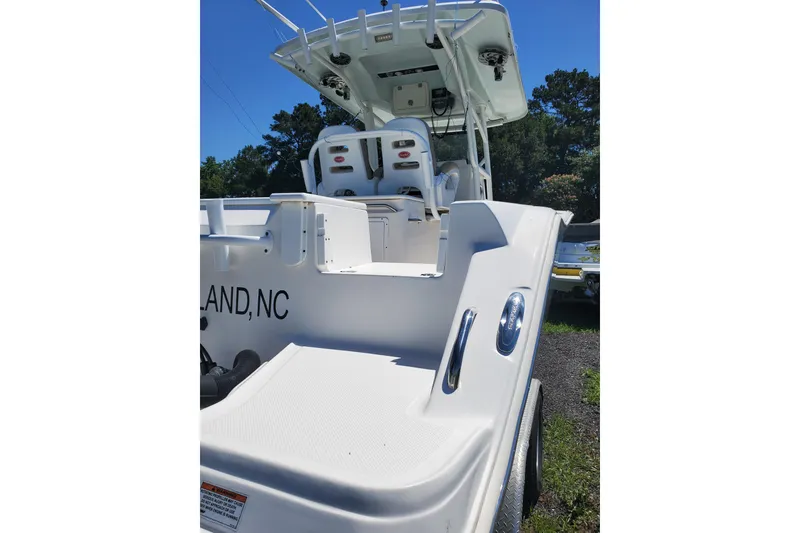Slide: The Image of 2015 Sea Fox 286 Commander boat, rear view, white exterior, parked outdoors. - 14