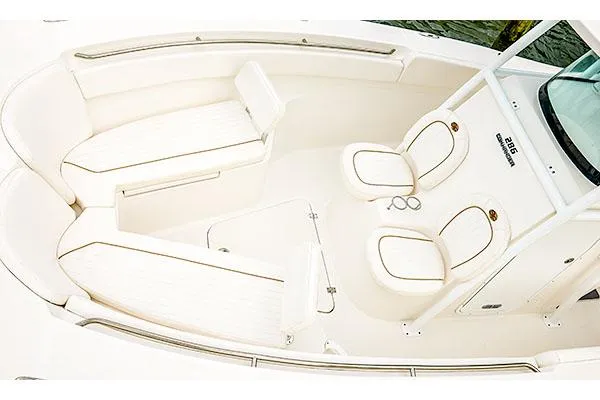 Slide: The Image of Manufacturer Provided Image: 2015 Sea Fox 286 Commander boat interior with white seating and console. - 2