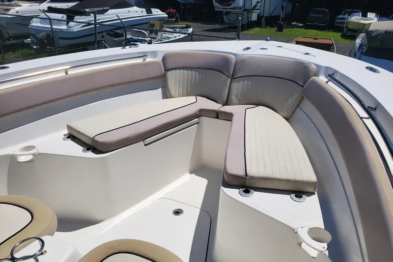 Slide: The Image of 2015 Sea Fox 286 Commander boat interior with cushioned seating and cup holders. - 21