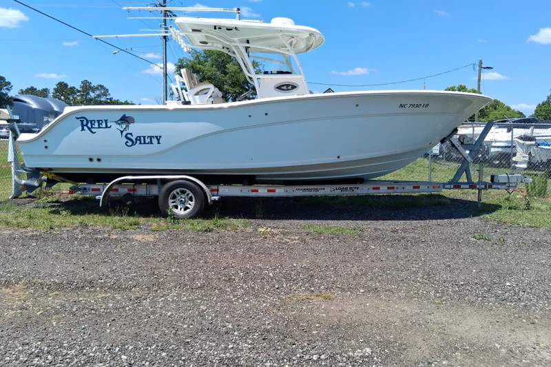 Slide: The Image of 2015 Sea Fox 286 Commander boat on trailer, labeled "Reel Salty," parked outdoors. - 31