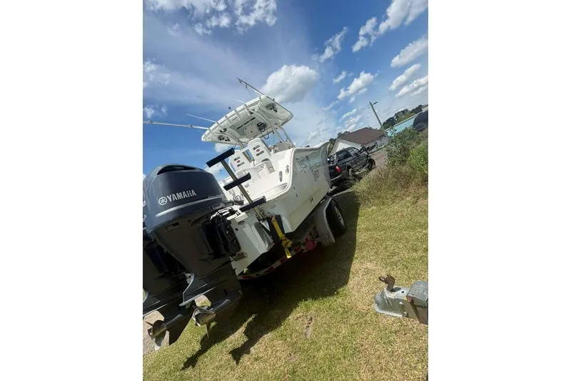 Slide: The Image of 2015 Sea Fox 286 Commander boat with Yamaha engines on grassy area under blue sky. - 7