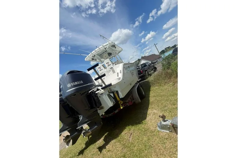 Slide: The Image of 2015 Sea Fox 286 Commander boat with Yamaha engines on a trailer, under a clear blue sky. - 9