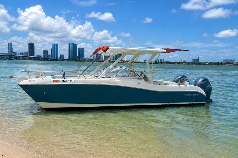 The Image of 2020 World Cat 255 DC boat on beach with city skyline. - 0