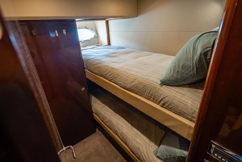 Slide: The Image of Bunk beds in 2010 Princess 95 Motor Yacht cabin with window view. - 111