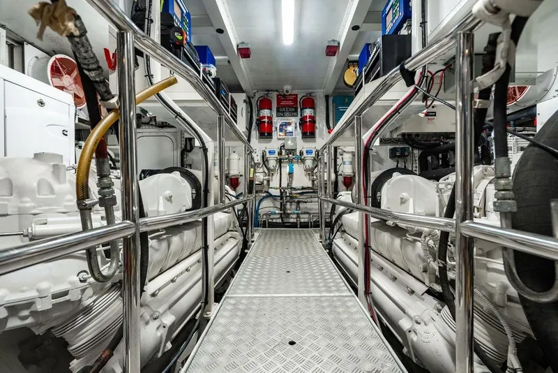 Slide: The Image of Engine room of 2010 Princess 95 Motor Yacht, featuring machinery and safety equipment. - 112