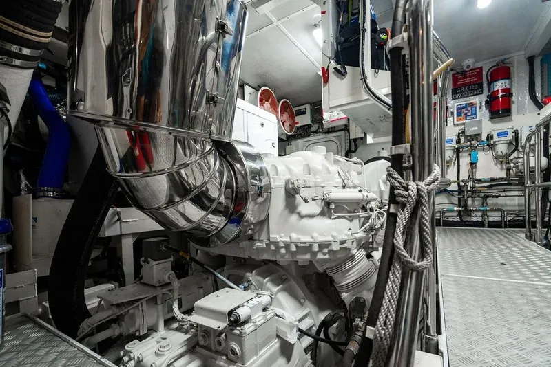 Slide: The Image of Engine room of a 2010 Princess 95 Motor Yacht, showcasing machinery and equipment. - 114