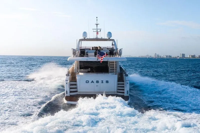Slide: The Image of Princess 95 Motor Yacht 2010 cruising on open sea, rear view with city skyline. - 128