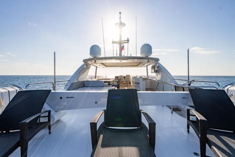 Slide: The Image of Luxurious 2010 Princess 95 Motor Yacht deck with sun loungers, ocean view, and clear sky. - 7