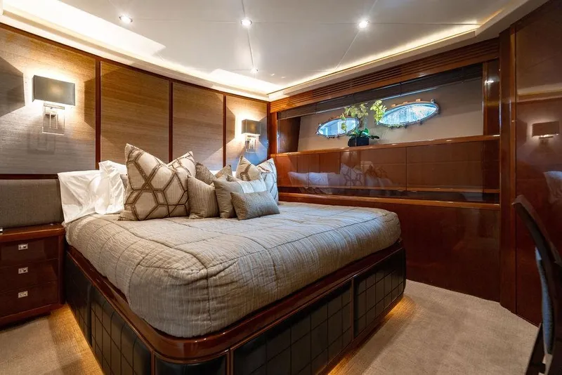 Slide: The Image of Luxurious bedroom interior of 2010 Princess 95 Motor Yacht with elegant wood paneling. - 79