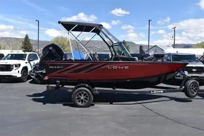 The Image of 2026 Lowe Fish & Ski 1700 boat on trailer, parked outdoors under clear sky. - 0