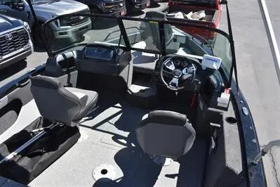 Slide: The Image of 2026 Lowe Fish & Ski 1700 boat interior with seating and steering wheel. - 14