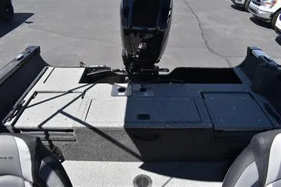Slide: The Image of 2026 Lowe Fish & Ski 1700 boat interior with motor, featuring seating and storage compartments. - 15