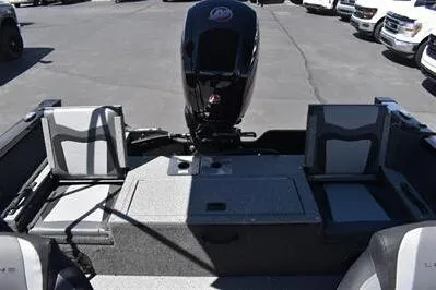 Slide: The Image of 2026 Lowe Fish & Ski 1700 boat interior with seating and motor. - 16
