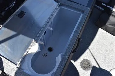Slide: The Image of 2026 Lowe Fish & Ski 1700 boat interior with open storage compartment. - 17