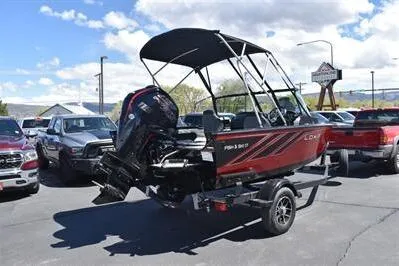 Slide: The Image of 2026 Lowe Fish & Ski 1700 boat on trailer, parked outdoors, with clear sky background. - 2