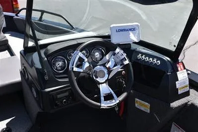 Slide: The Image of 2026 Lowe Fish & Ski 1700 boat dashboard with steering wheel and Lowrance display. - 26