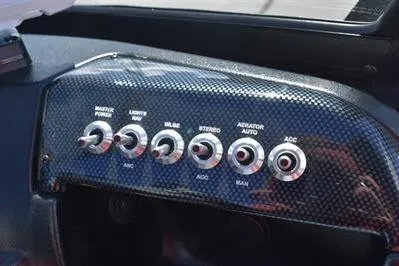 Slide: The Image of Control panel of 2026 Lowe Fish & Ski 1700 boat with toggle switches. - 31
