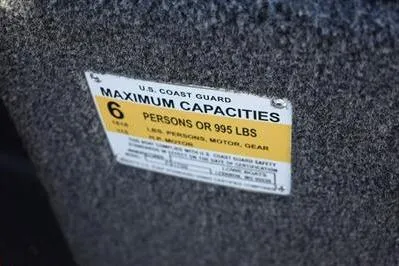 Slide: The Image of Capacity label on 2026 Lowe Fish & Ski 1700 boat, maximum 6 persons or 995 lbs. - 34