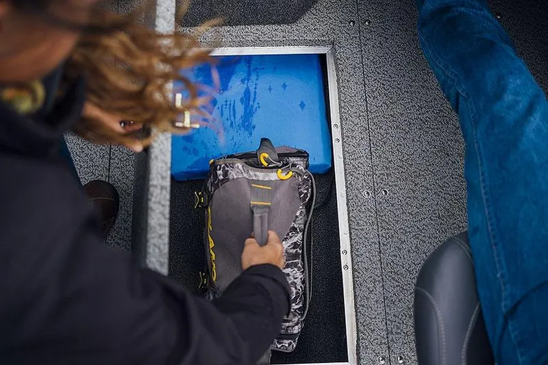 Slide: The Image of Manufacturer Provided Image: Person accessing storage compartment on 2026 Lowe Fish & Ski 1700 boat. - 37