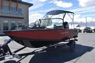 Slide: The Image of 2026 Lowe Fish & Ski 1700 boat on trailer, parked outdoors under blue sky. - 5