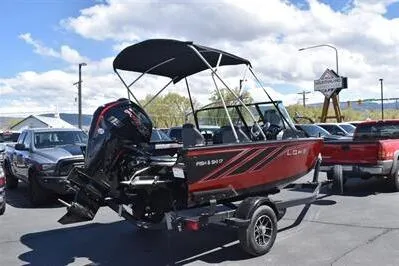 Slide: The Image of 2026 Lowe Fish & Ski 1700 boat on trailer, parked outdoors under a blue sky. - 7