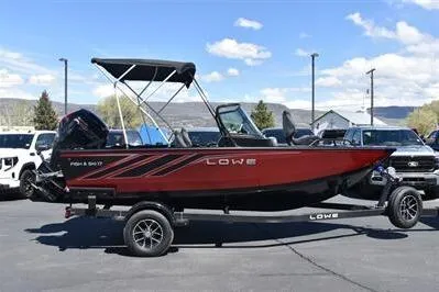 Slide: The Image of 2026 Lowe Fish & Ski 1700 boat on trailer, parked outdoors under clear sky. - 8