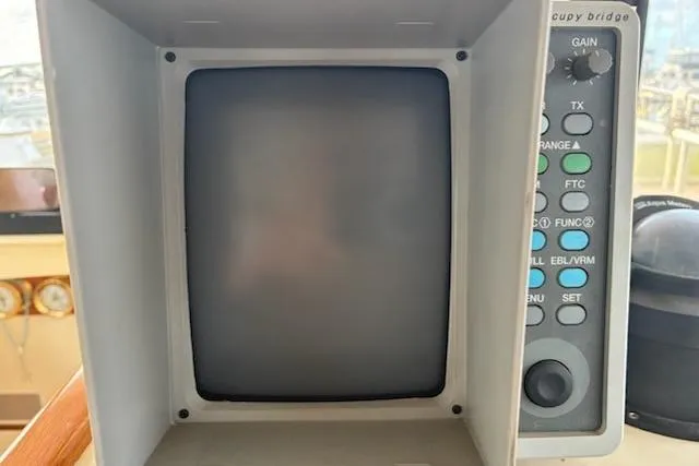 Slide: The Image of 2003 Camano Troll boat control panel with screen and buttons. - 13