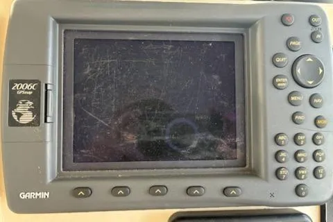 Slide: The Image of Garmin GPS device on a 2003 Camano Troll boat, featuring a scratched screen and control buttons. - 14