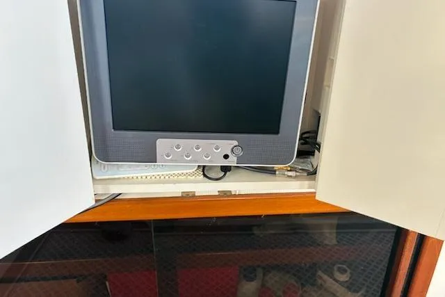 Slide: The Image of 2003 Camano Troll boat interior with a mounted monitor in a cabinet. - 16