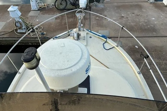 Slide: The Image of 2003 Camano Troll boat docked, featuring a radar dome and bow railing. - 3