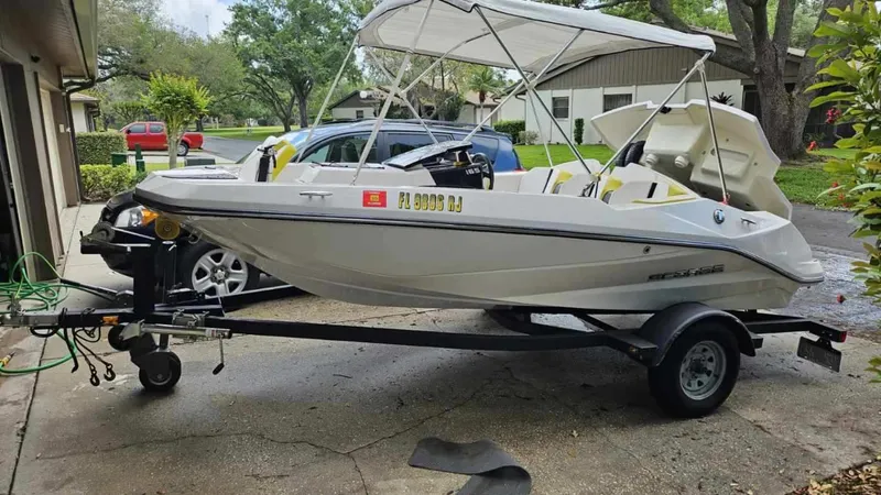 Slide: The Image of 2017 Scarab 165 G boat on trailer in residential area. - 1
