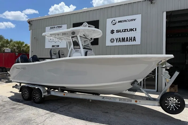 The Image of 2026 Sea Pro 262 Offshore boat on trailer outside dealership. - 1