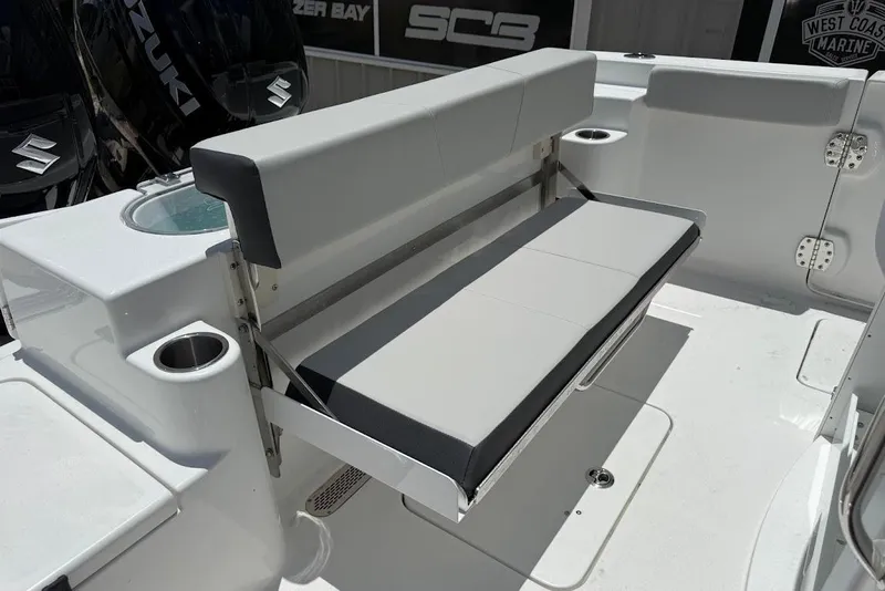 Slide: The Image of 2026 Sea Pro 262 Offshore boat with foldable seating and Suzuki engines in a marine setting. - 17