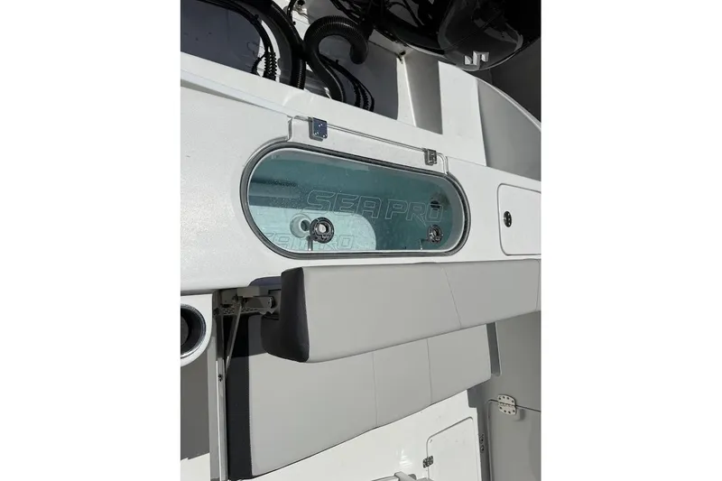 Slide: The Image of 2026 Sea Pro 262 Offshore boat interior with storage compartment and sleek design. - 19