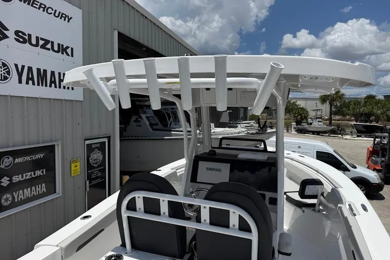 Slide: The Image of 2026 Sea Pro 262 Offshore boat at dealership with Yamaha, Suzuki, and Mercury signage. - 22