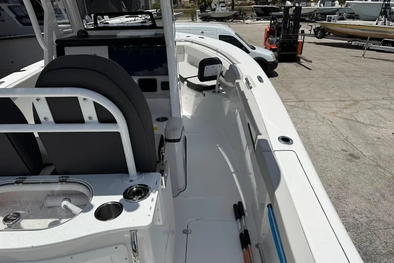 Slide: The Image of 2026 Sea Pro 262 Offshore boat interior with seating and fishing rod holders. - 23