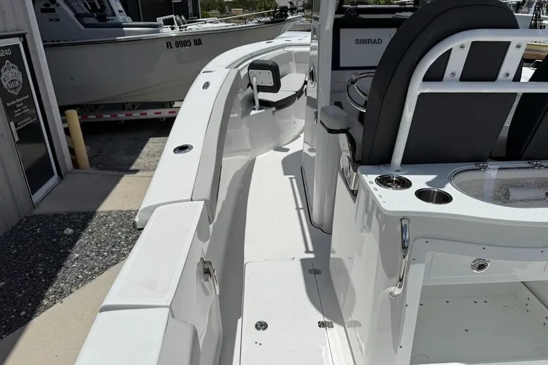 Slide: The Image of 2026 Sea Pro 262 Offshore boat interior with seating and control panel. - 24