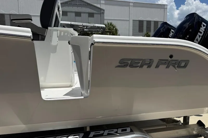 Slide: The Image of 2026 Sea Pro 262 Offshore boat with Suzuki engines, docked outdoors. - 25