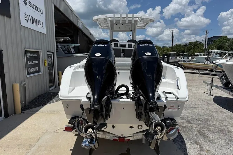 Slide: The Image of 2026 Sea Pro 262 Offshore boat with dual outboard engines at a dealership. - 6