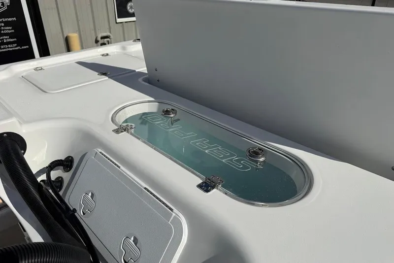 Slide: The Image of 2026 Sea Pro 250 Bay boat deck with storage compartments and logo detail. - 10