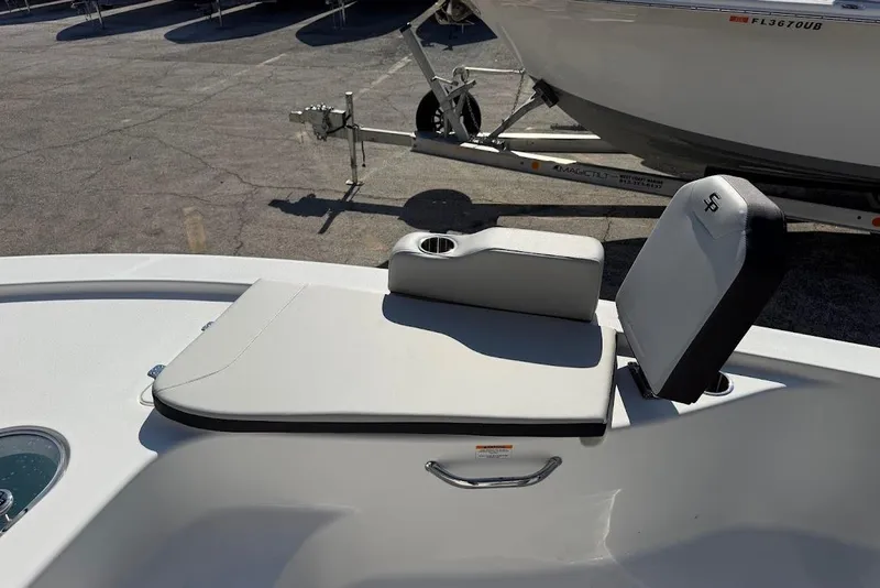 Slide: The Image of 2026 Sea Pro 250 Bay boat seat with cup holder, parked on a trailer. - 14