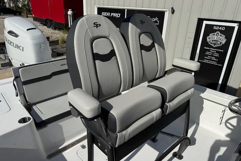 Slide: The Image of 2026 Sea Pro 250 Bay boat seats with Suzuki engine in background. - 15
