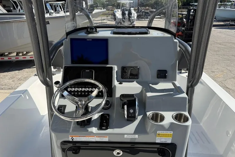 Slide: The Image of Center console of 2026 Sea Pro 250 Bay boat with steering wheel and controls. - 16