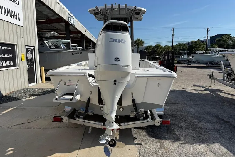 Slide: The Image of 2026 Sea Pro 250 Bay boat with 300 horsepower engine at a dealership. - 7