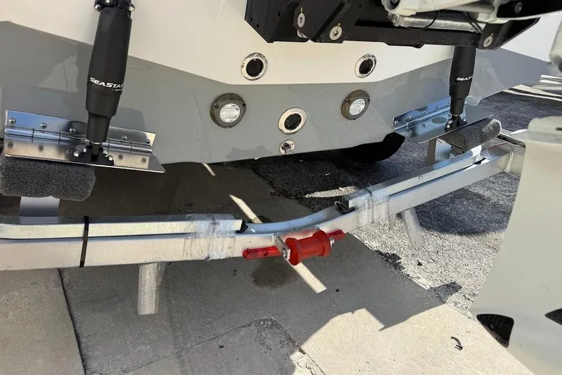Slide: The Image of 2026 Sea Pro 250 Bay boat trailer with hydraulic components and support brackets. - 8