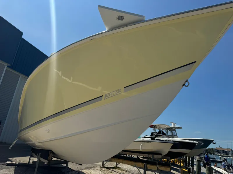 Slide: The Image of 2006 Jupiter 31 CC FWD boat docked under sunny skies. - 1