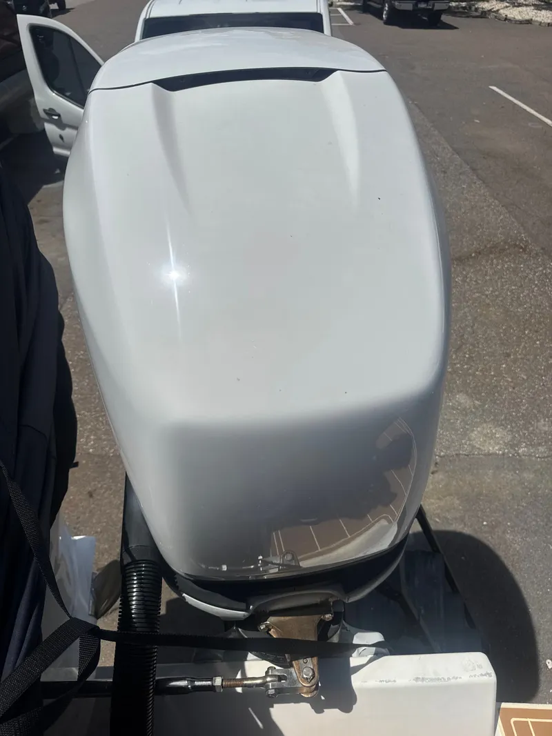 Slide: The Image of Jupiter 31 CC FWD Seating 2006 outboard motor on parking lot. - 12