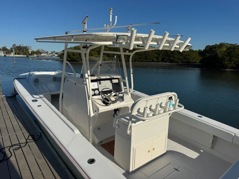 Slide: The Image of 2006 Jupiter 31 CC boat with helm station by the water. - 14