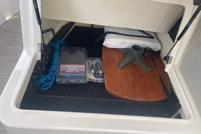 Slide: The Image of Storage compartment in a 2020 Regal 28 Express boat with accessories and equipment. - 11