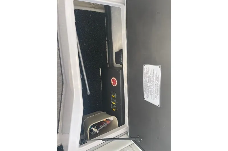 Slide: The Image of 2020 Regal 28 Express boat interior compartment with control panel and storage. - 14